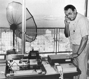 Toby Massey uses a Leafax 35 transmitter, lower left, a compander, upper right, and a satellite dish to transmit photos from the Havana Libre Hotel in 1990. AP was covering Fidel Castro's campaign against TV Marti programming. (AP Photo/Charles Tasnadi)